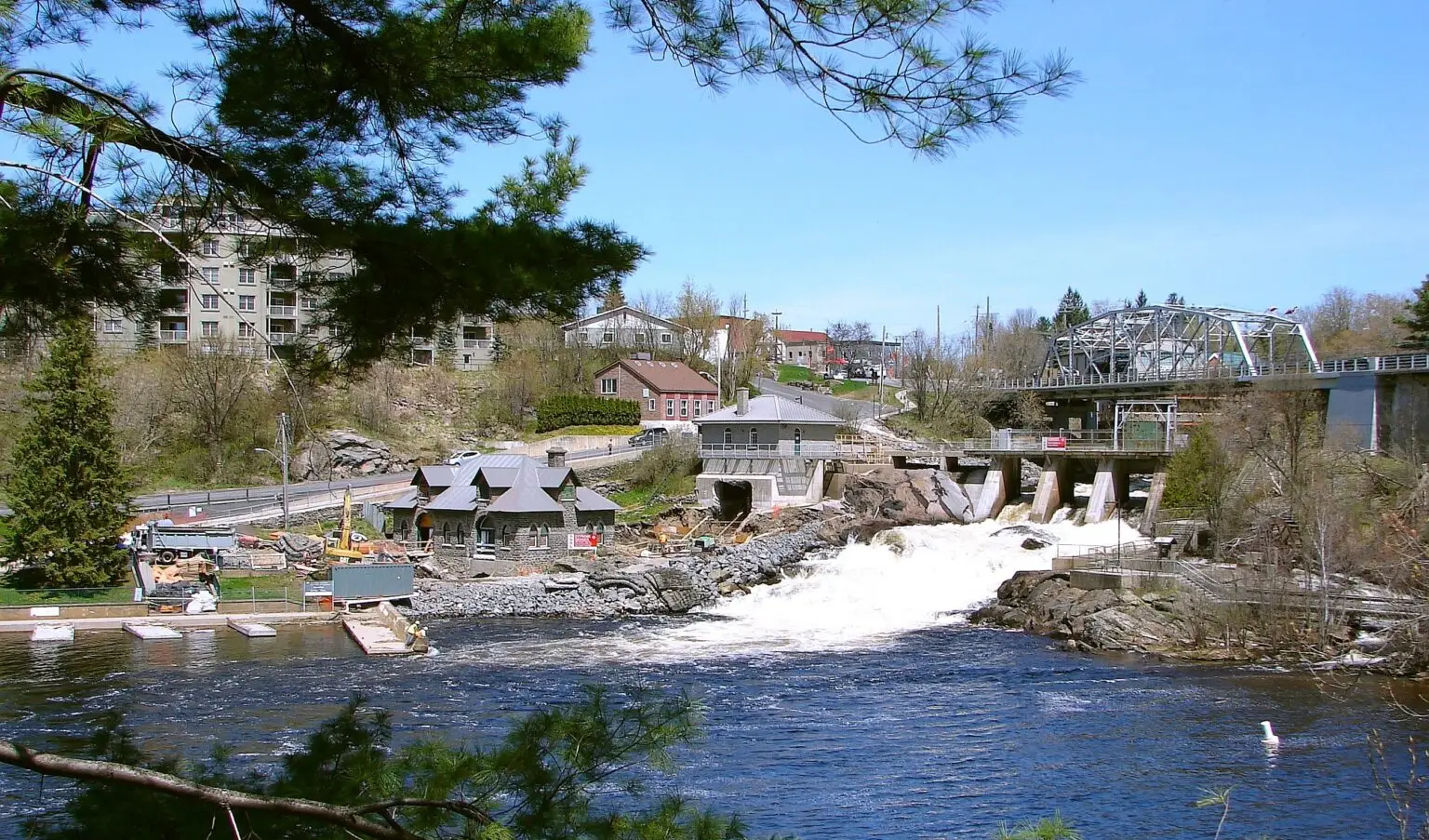 Muskoka river with a dam and buildings in Bracebridge, Ontario